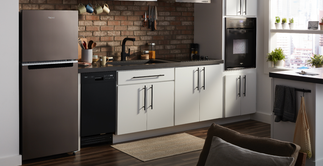 photo of a small apartment kitchen with a top freezer refrigerator